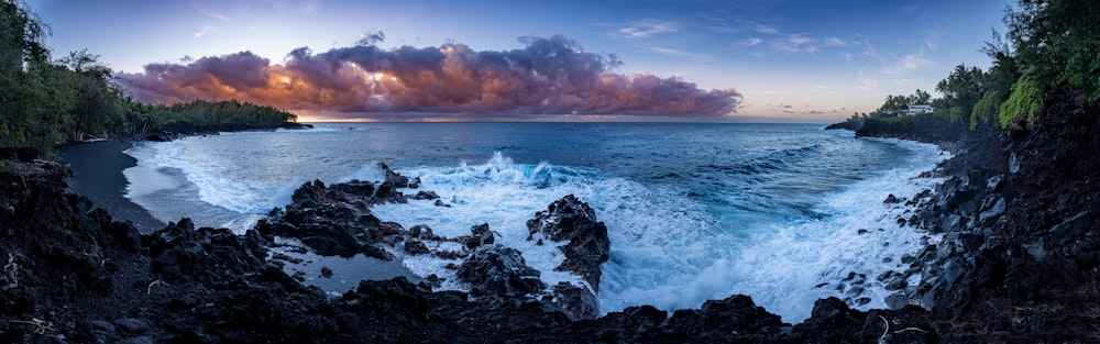 a rocky beach with a sunset