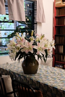 Elegant white and pink artificial lilies in a decorative pot.