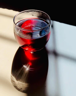 Artistic shot of a red product with shadows creating depth and warmth