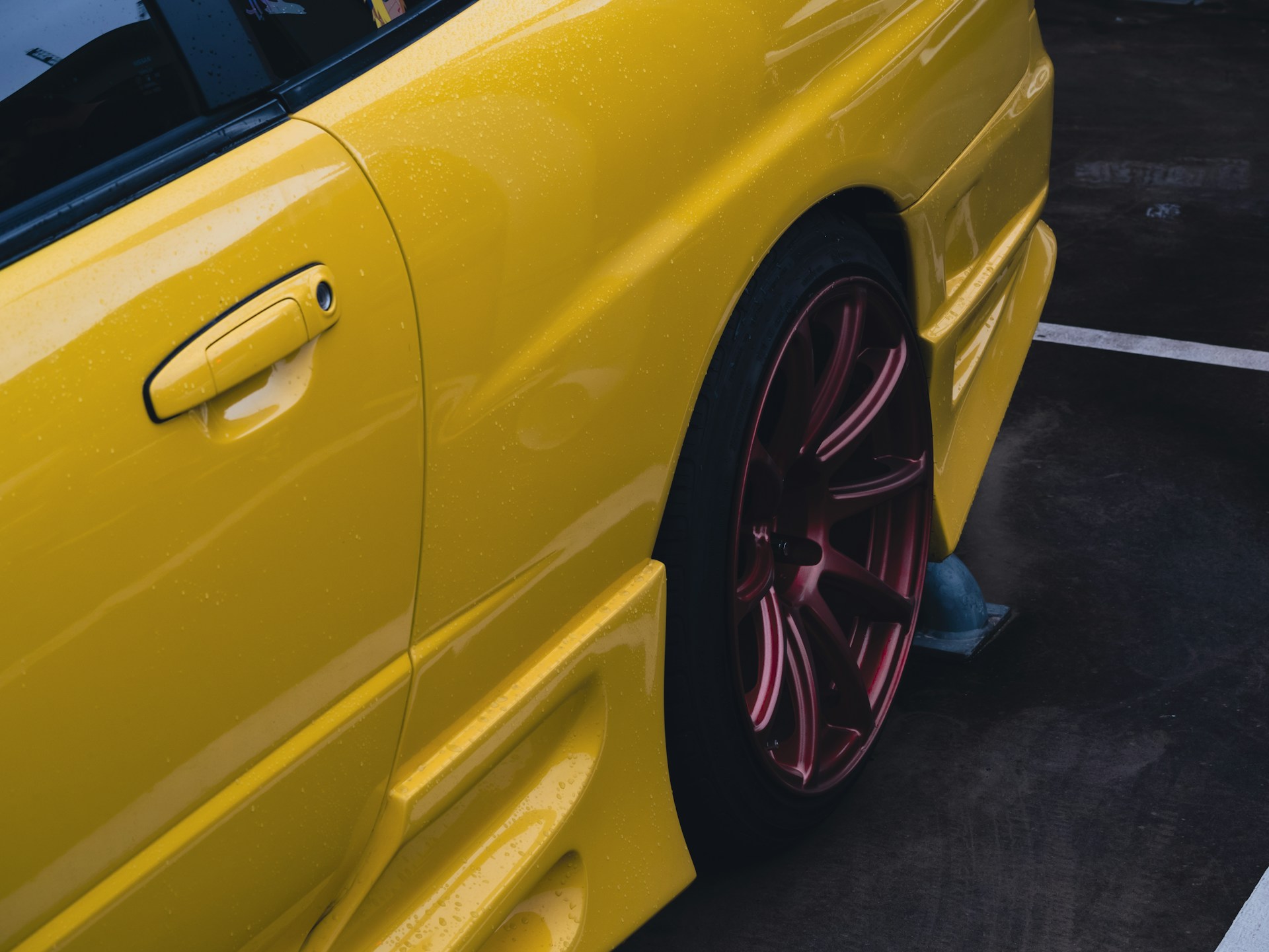a yellow car with a red rim