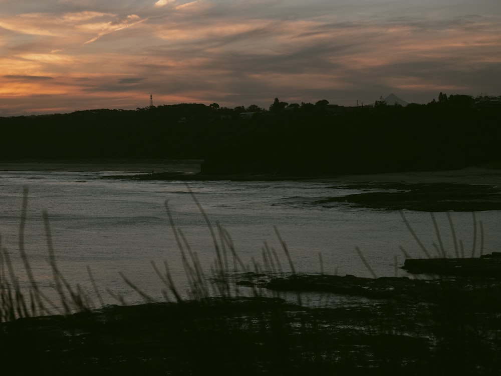 a body of water with a land in the back