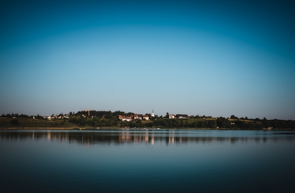 a body of water with houses in the background