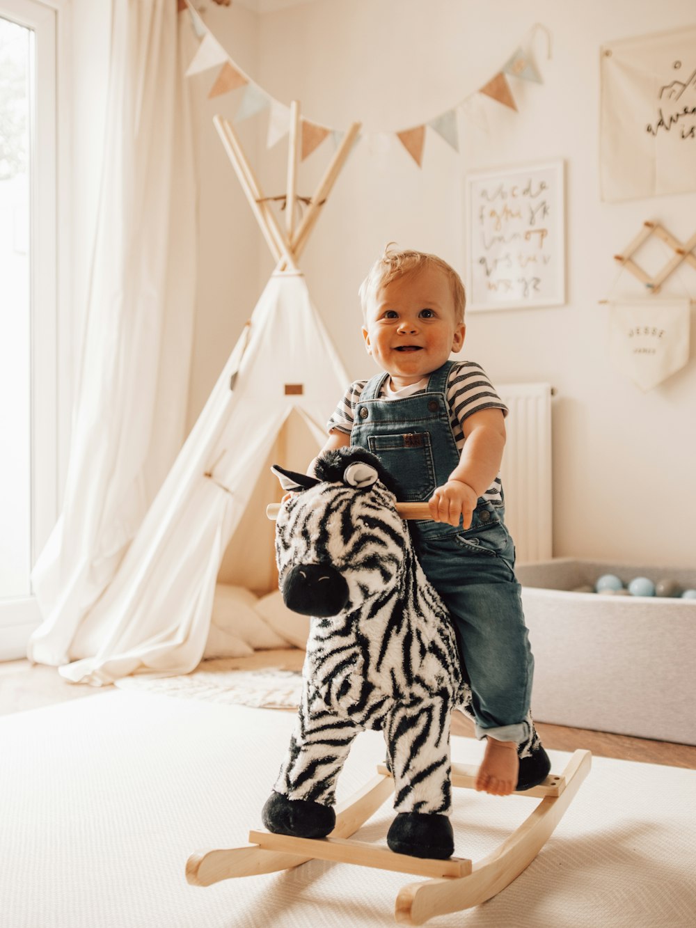 a boy sitting on a toy horse