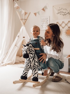 a woman and a child sitting on a bed