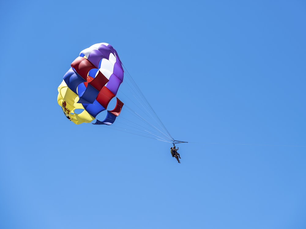 a person in the air with a parachute