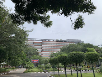 A bustling commercial office complex with well-maintained landscaping and visible signage of Vorinos Solutions.