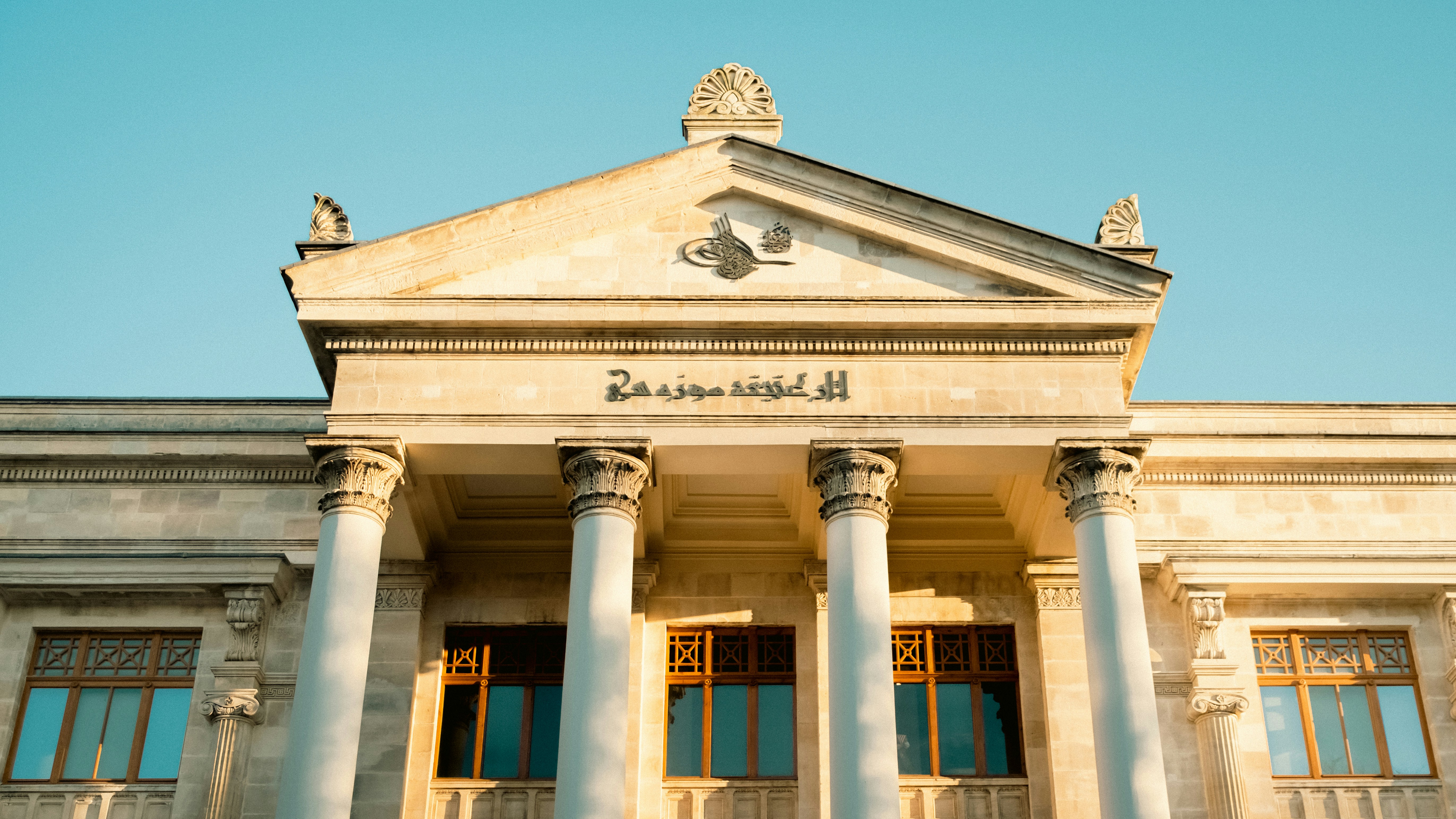 a building with columns and a blue sky