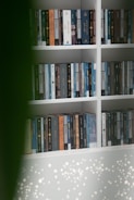 A bookshelf lined with academic books on sociology and Islamic studies.
