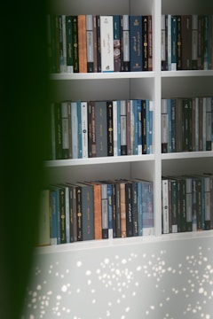 A bookshelf lined with academic books on sociology and Islamic studies.