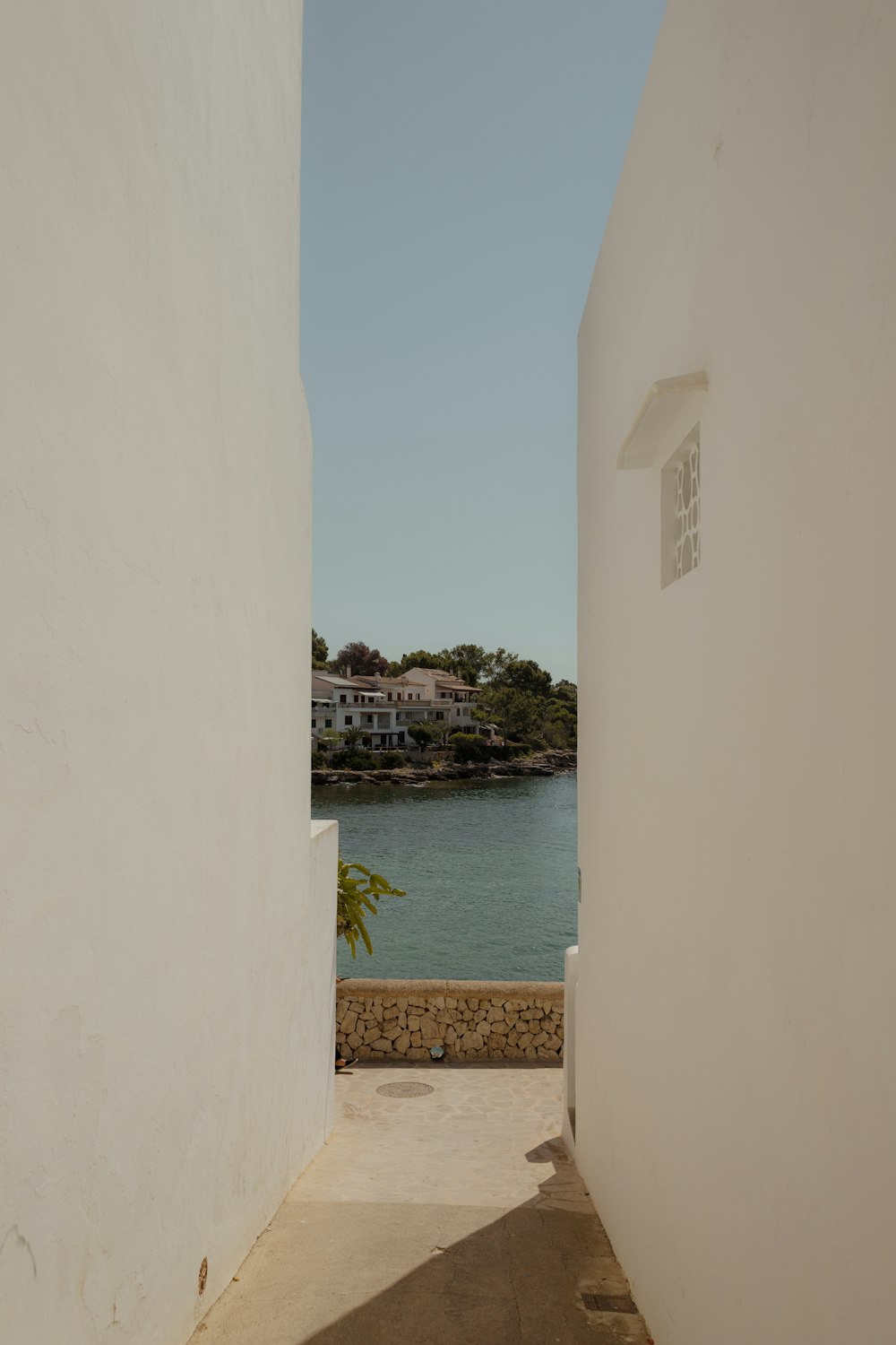 a white building with a body of water in the background