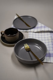 a plate with a cup and a spoon on it