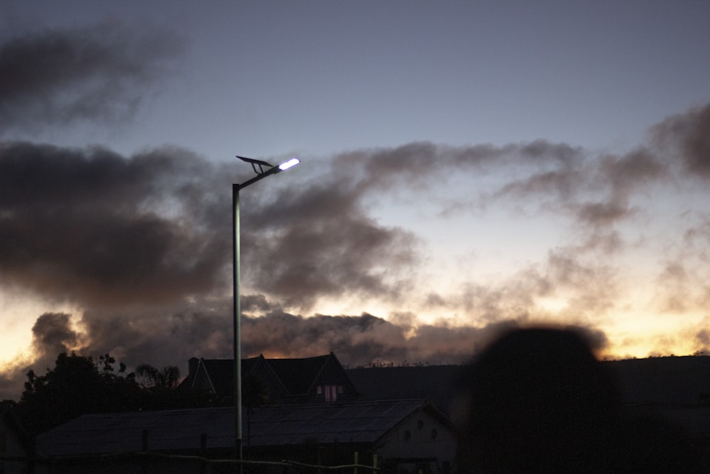 a street light with a cloudy sky