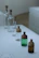 Image showing several tiny decant bottles lined up on a wooden surface.