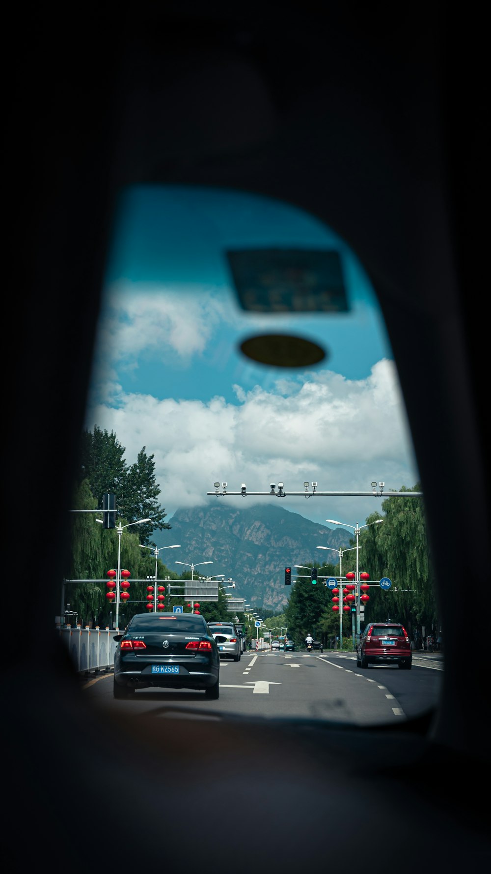 a large blue and white object above a street with cars