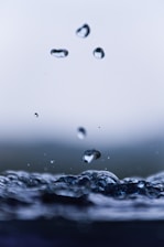 Close-up of crystal-clear water droplets on a sleek water filter surface, highlighting purity and precision.