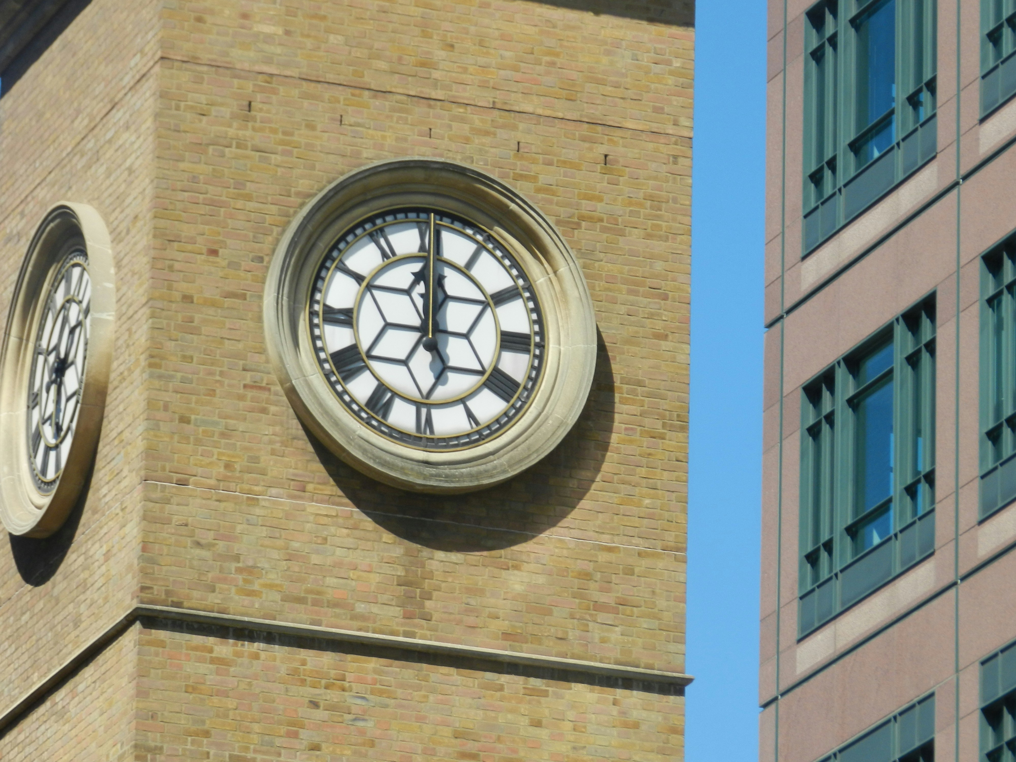 A clock on a brick building photo – Free Building Image on Unsplash