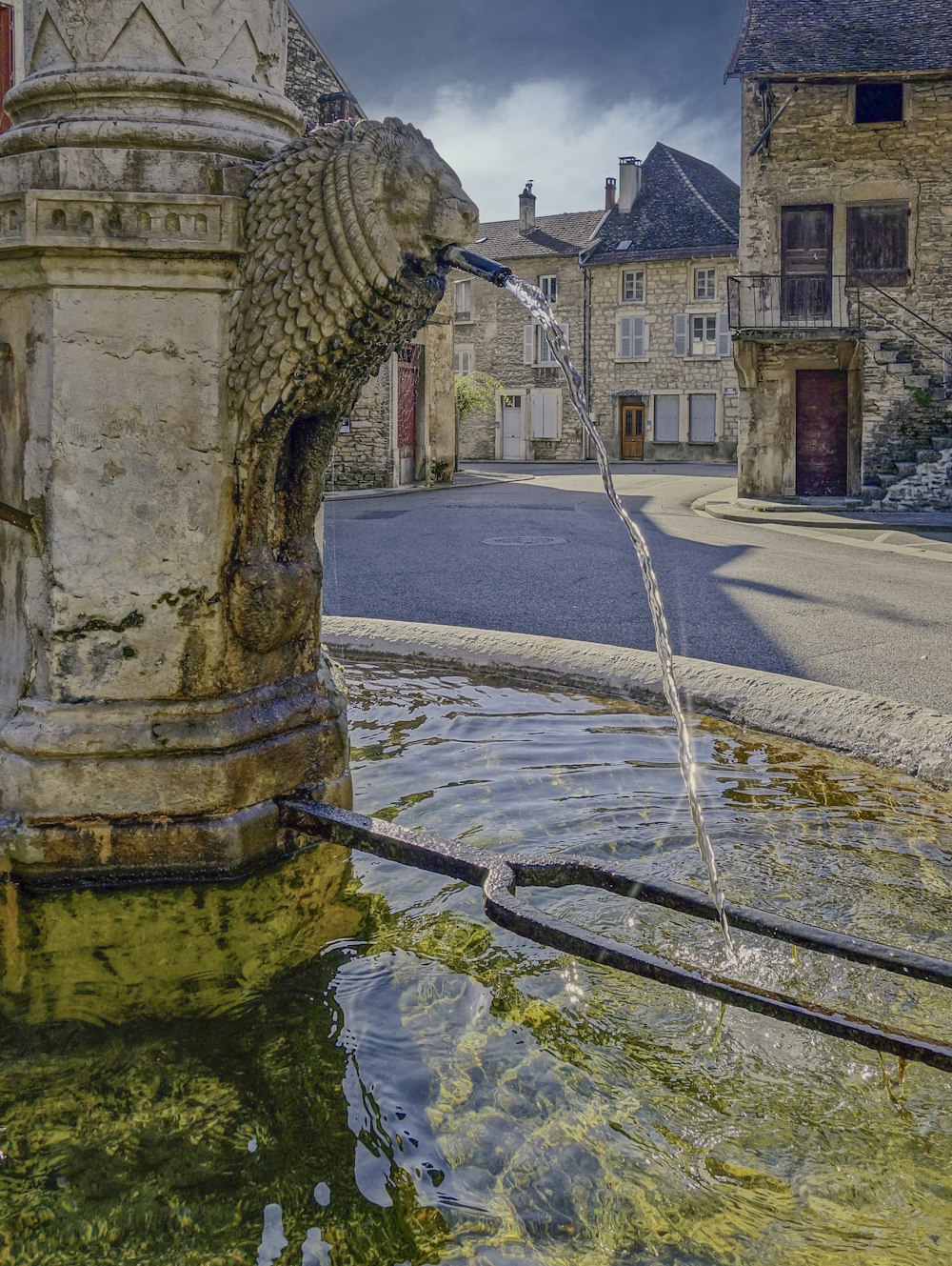 a stone fountain in a town