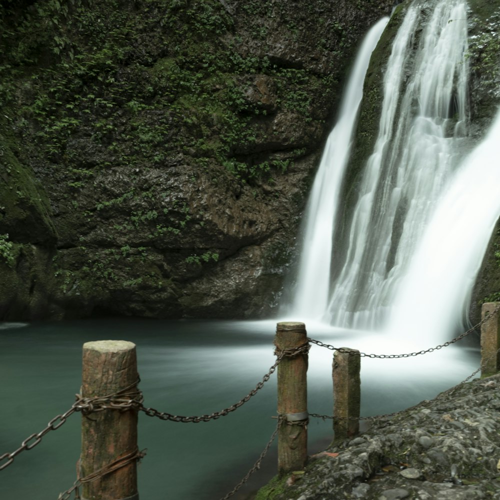 a waterfall with a rope