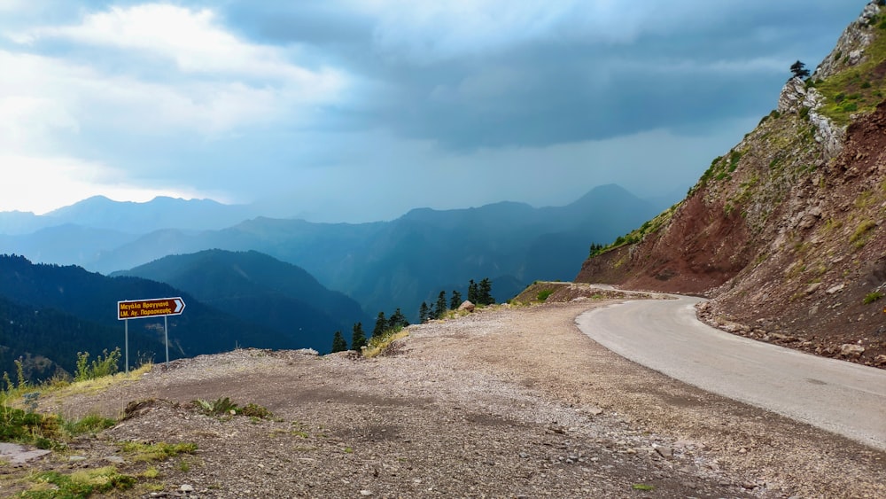 a road with mountains in the background