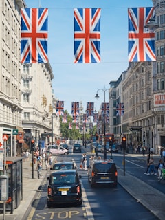 a street with cars and flags on it