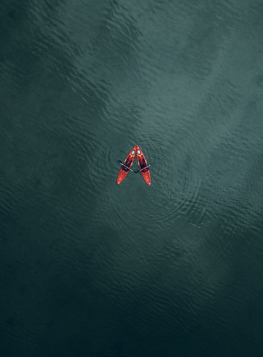 a red and white boat on water