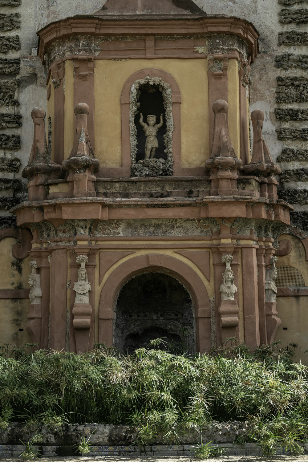 a stone building with statues