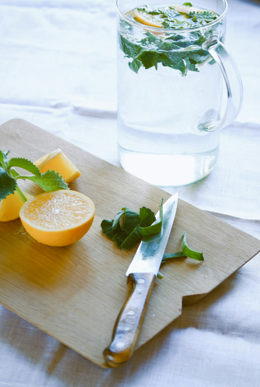 a glass of milk next to a sliced orange and a glass of milk