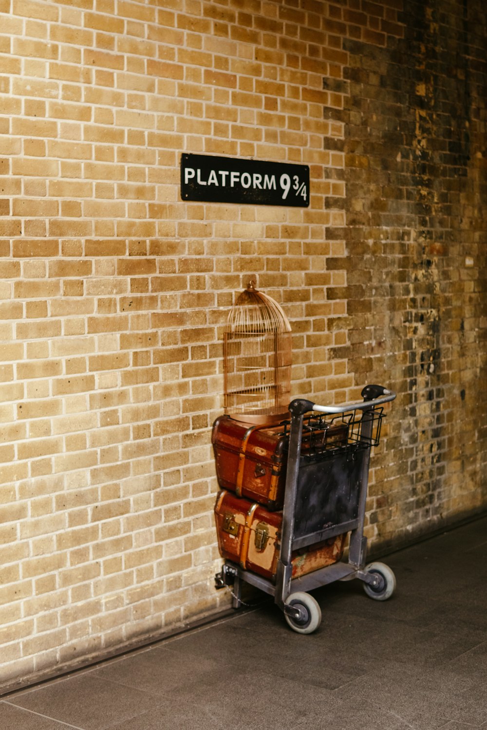 a cart is parked next to a brick wall