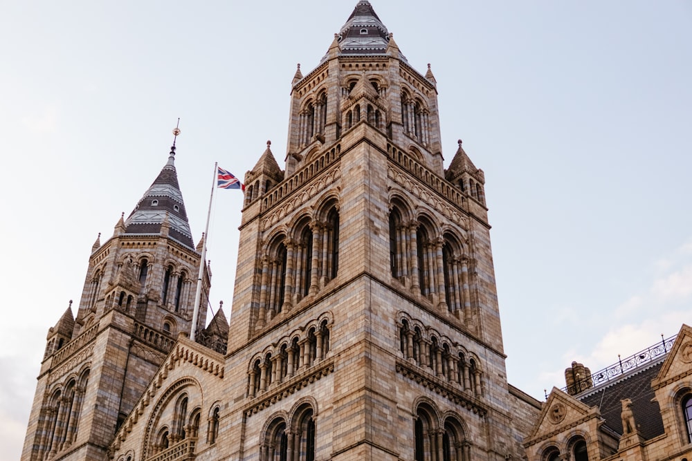 a large stone building with a flag on top