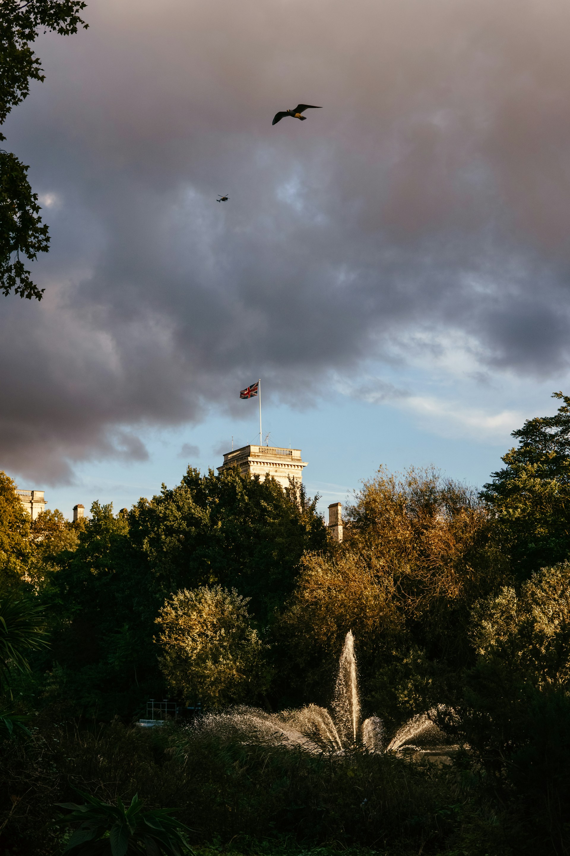 a building with a flag on top and trees around it