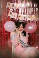 a person holding a pink balloon