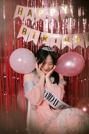 a person holding a pink balloon