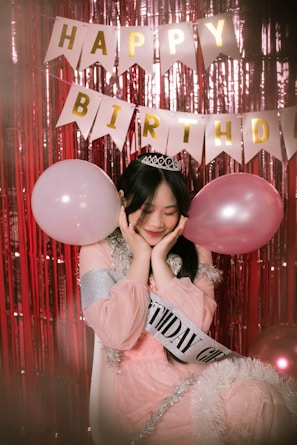 a person holding a pink balloon