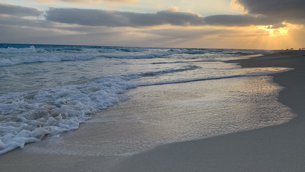 a beach with waves crashing on it