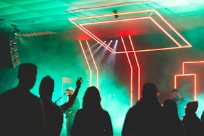 An audience enjoying a live music performance with neon lights.