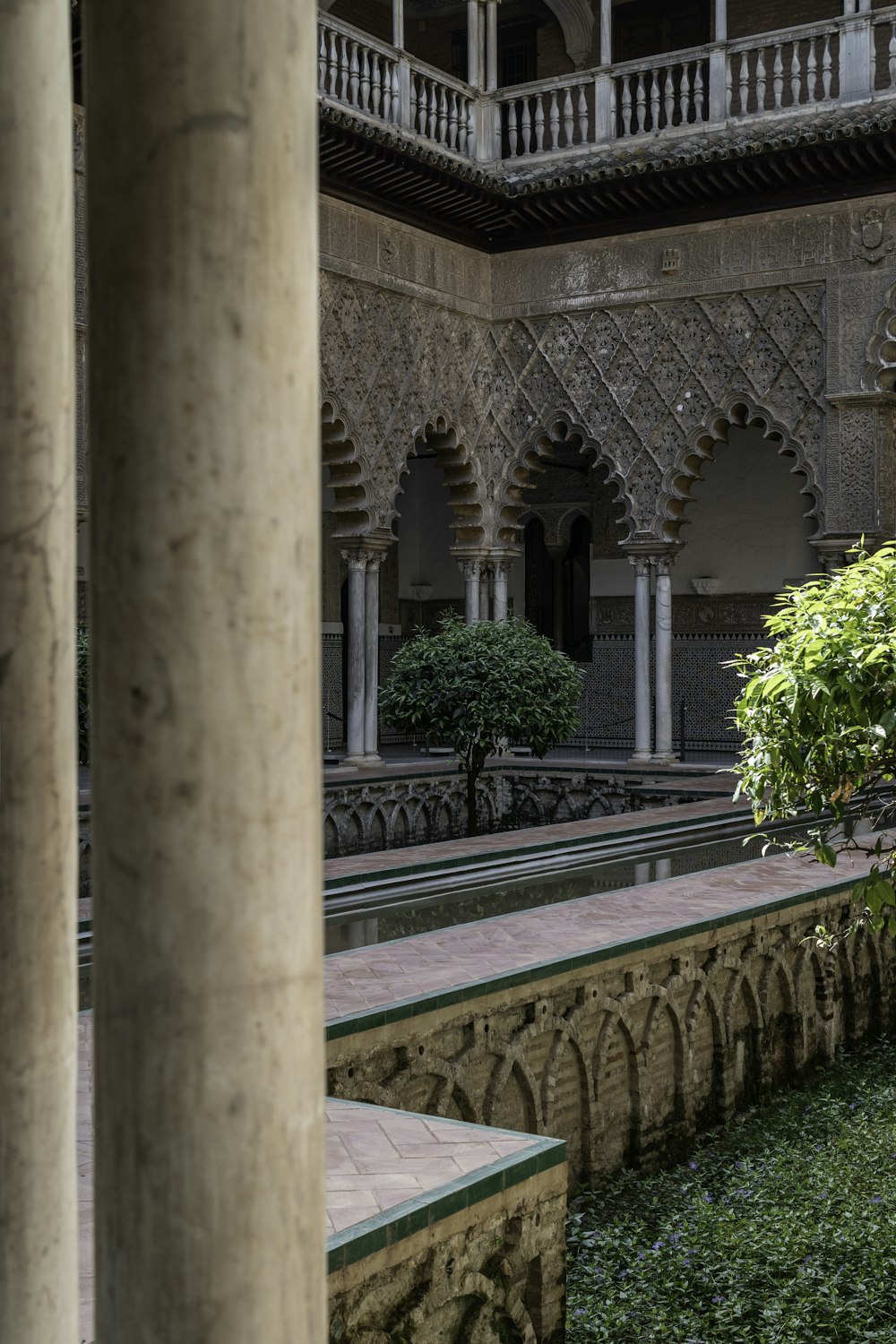 a building with a stone wall and a stone walkway