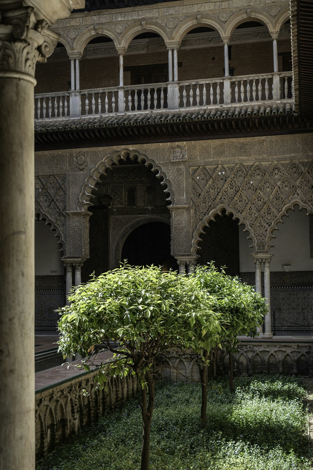 a courtyard with a large building in the background