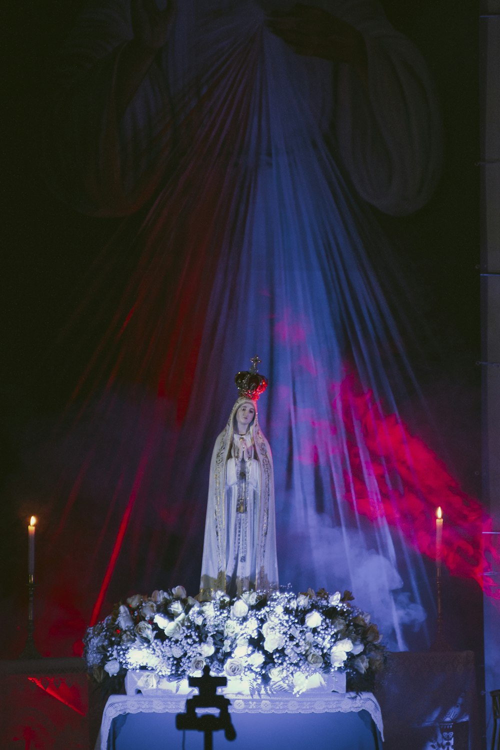 a statue of a person with a crown and a long blue dress