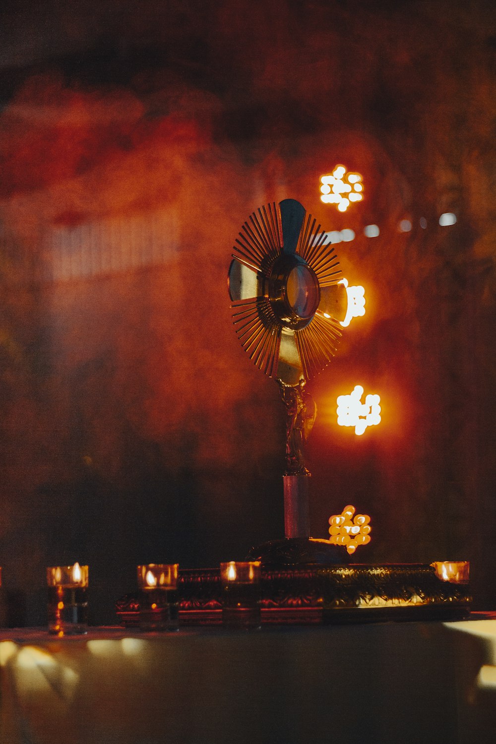 a large statue with candles in front of it