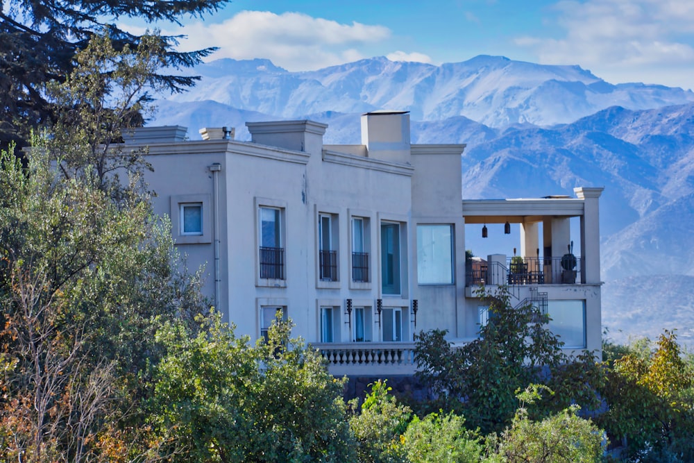 a white house with a mountain in the background