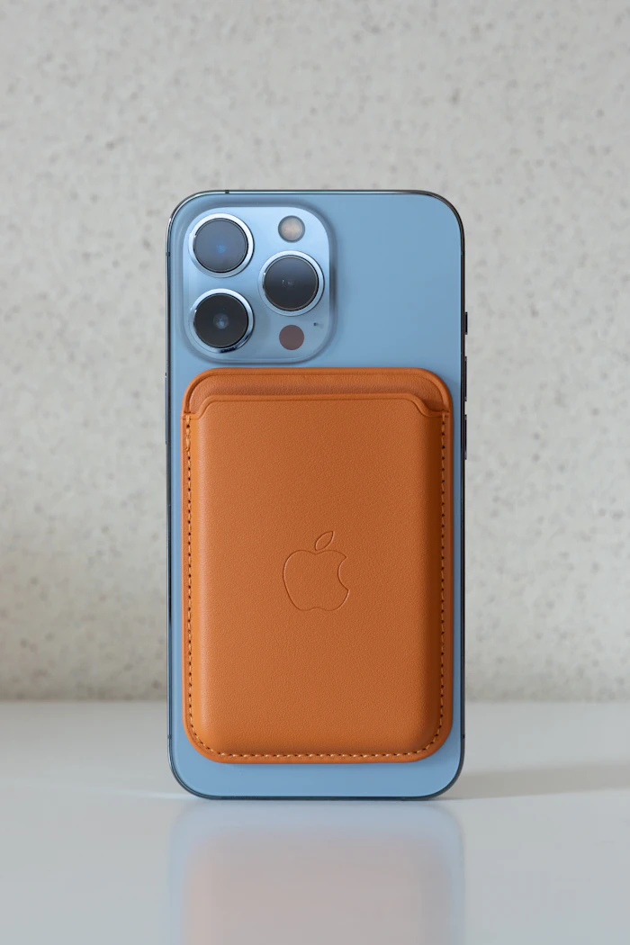iPhone with an orange magnetic card wallet attached