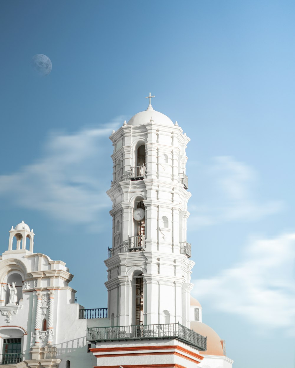 a white building with a clock tower