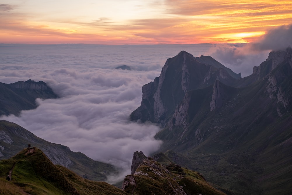 a mountain with clouds below