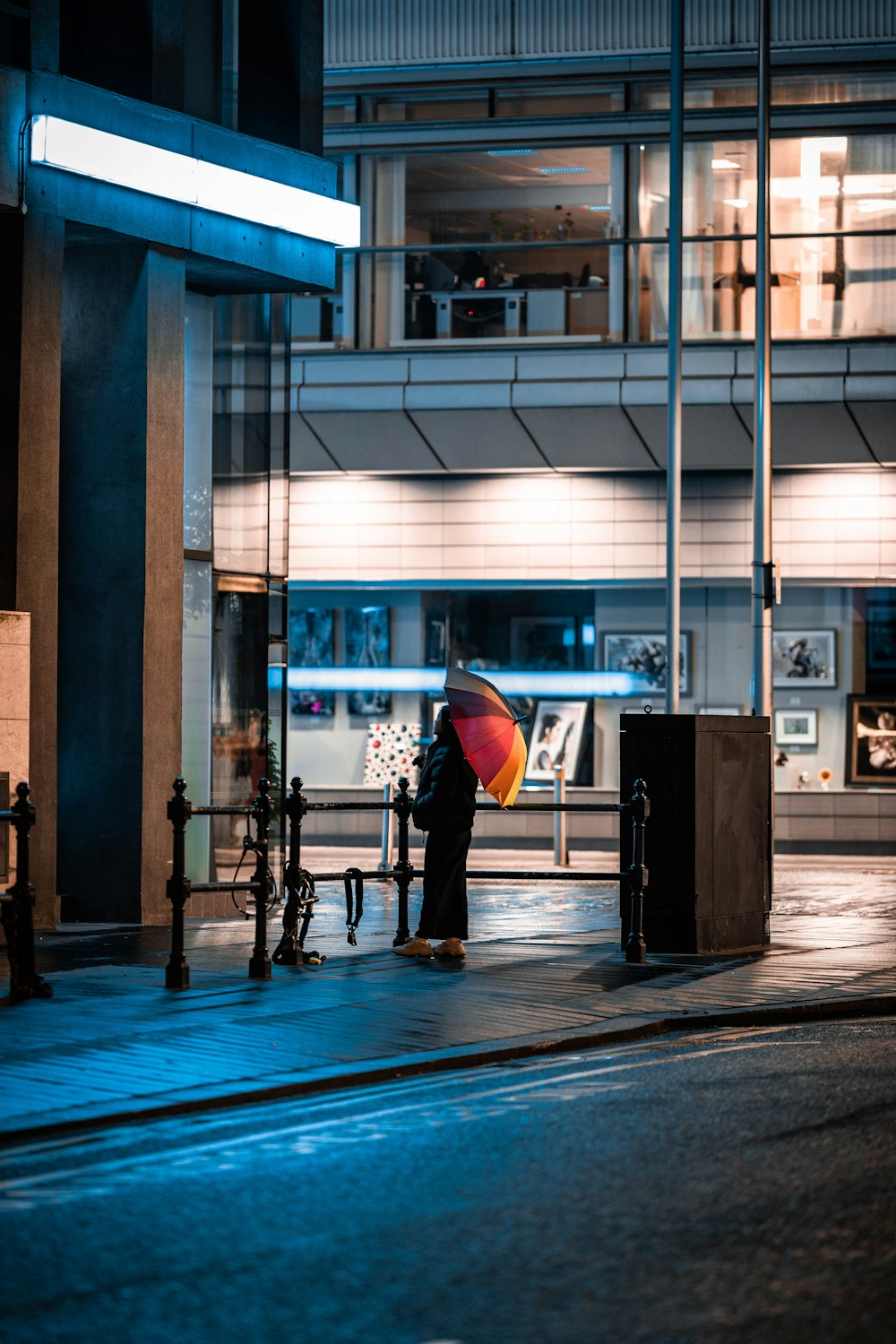 a person stands under an umbrella