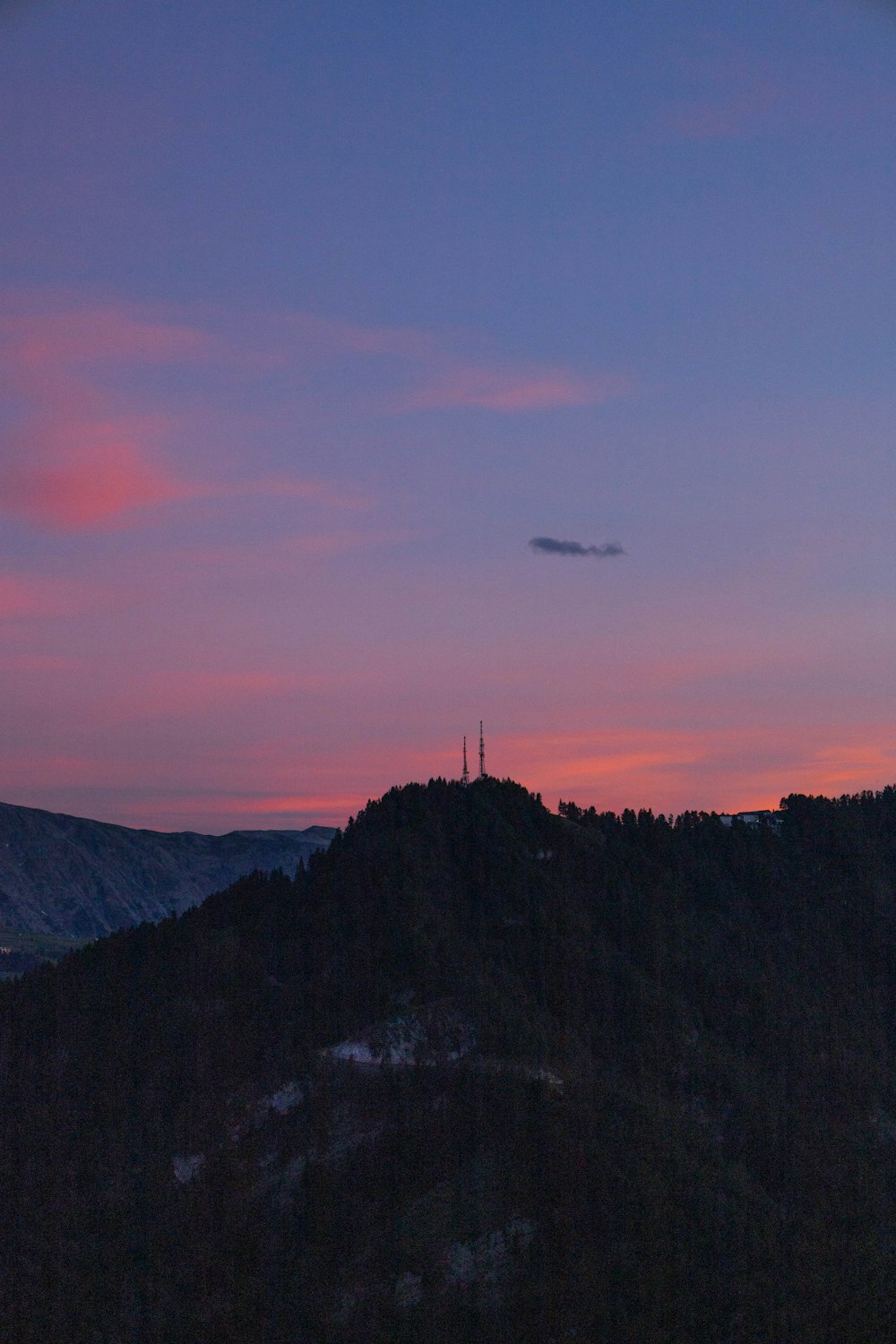 a mountain with a sunset in the background