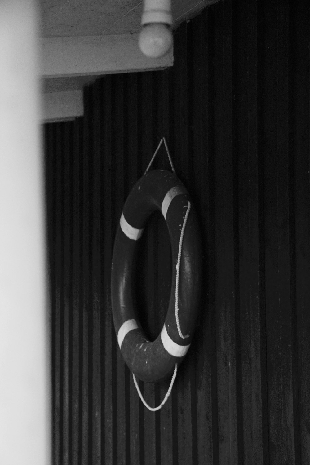 a black and white shoe on a black door