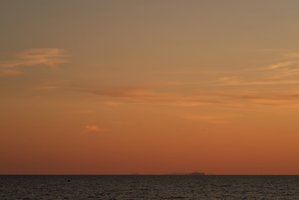 a sunset over a body of water