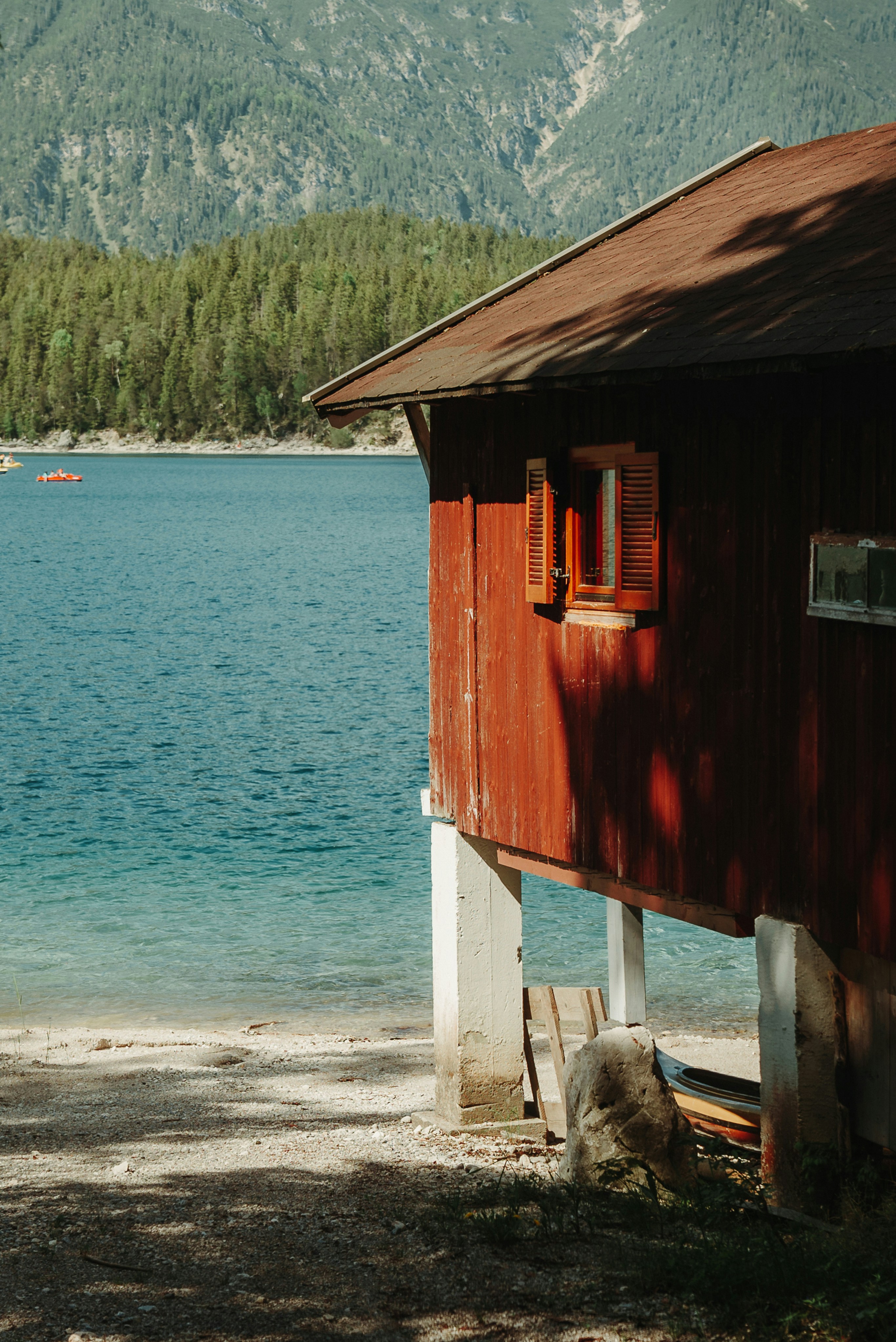 a wooden building next to a body of water
