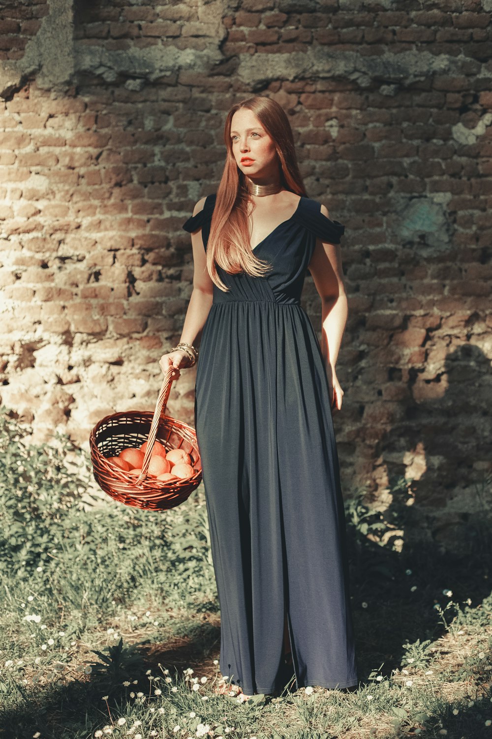 uma mulher em um vestido segurando uma cesta e uma cesta