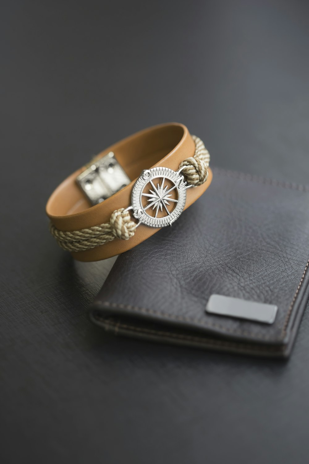 a gold ring on a black wallet
